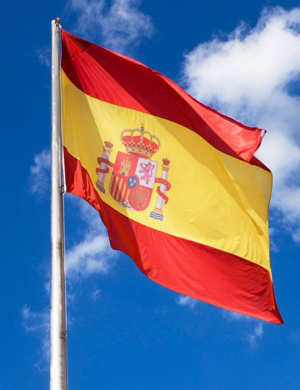 spanish-flag-waiving-blue-sky
